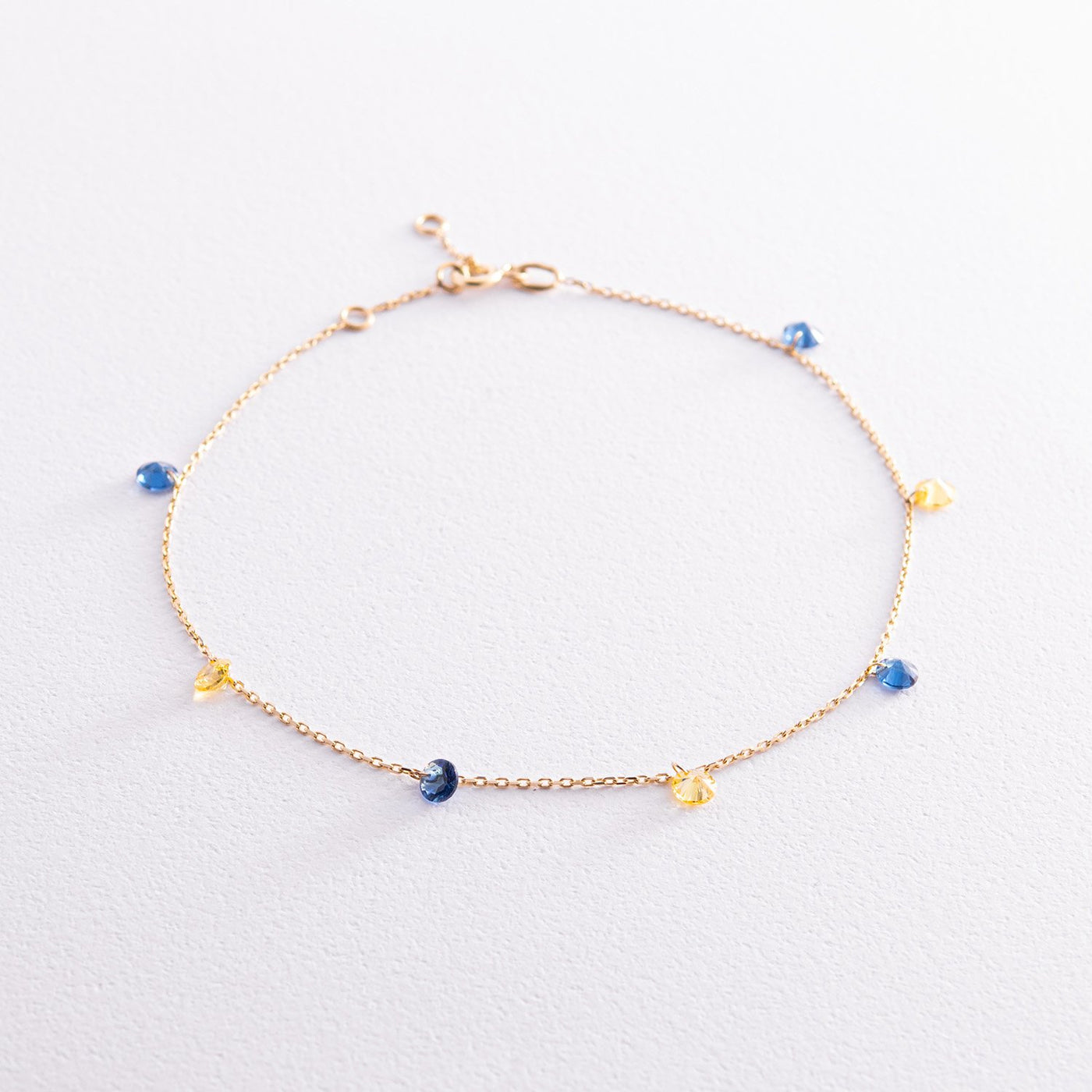 Gold anklet "Ukraine" (blue and yellow cubic zirconia)