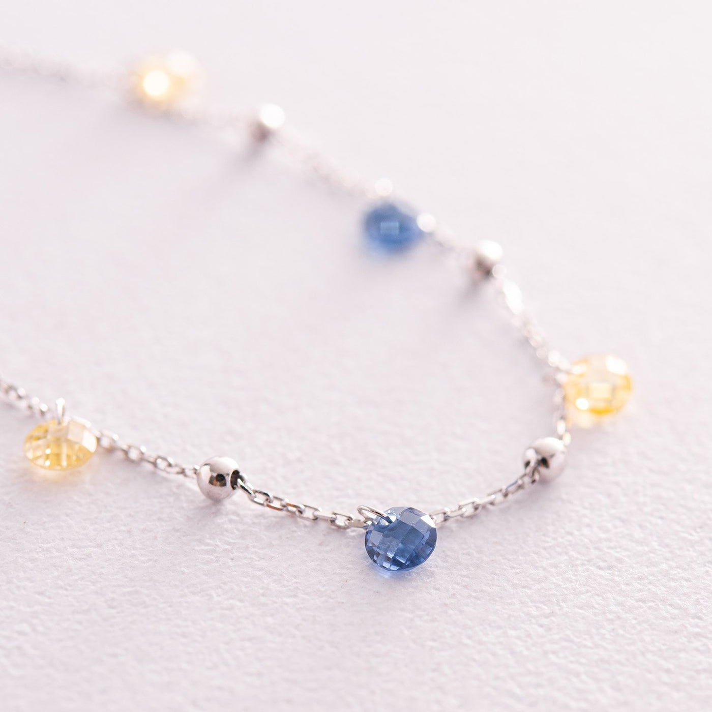 Gold Bracelet "Independent" with balls (blue and yellow cubic zirconia)