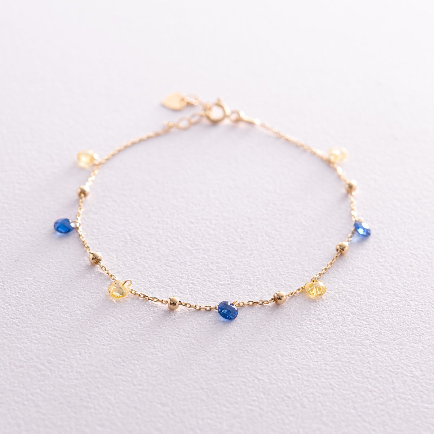 Gold Bracelet "Independent" with balls (blue and yellow cubic zirconia)