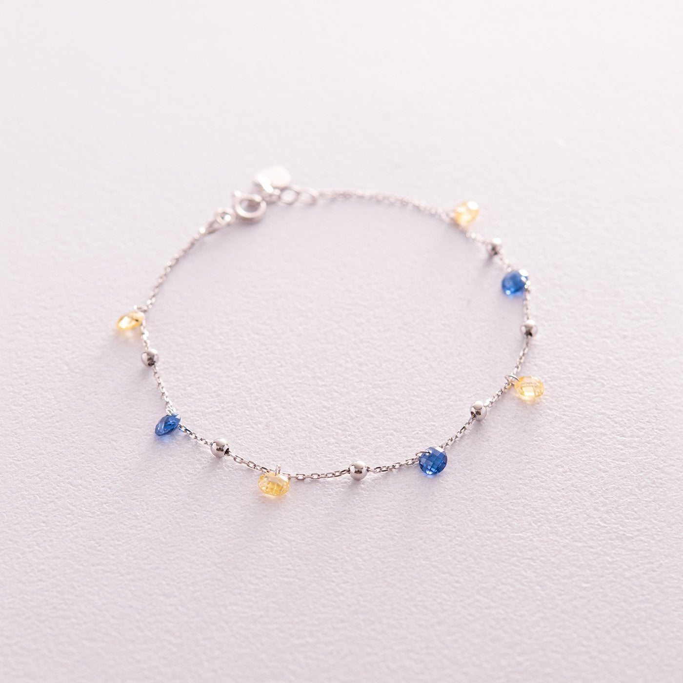 Gold Bracelet "Independent" with balls (blue and yellow cubic zirconia)