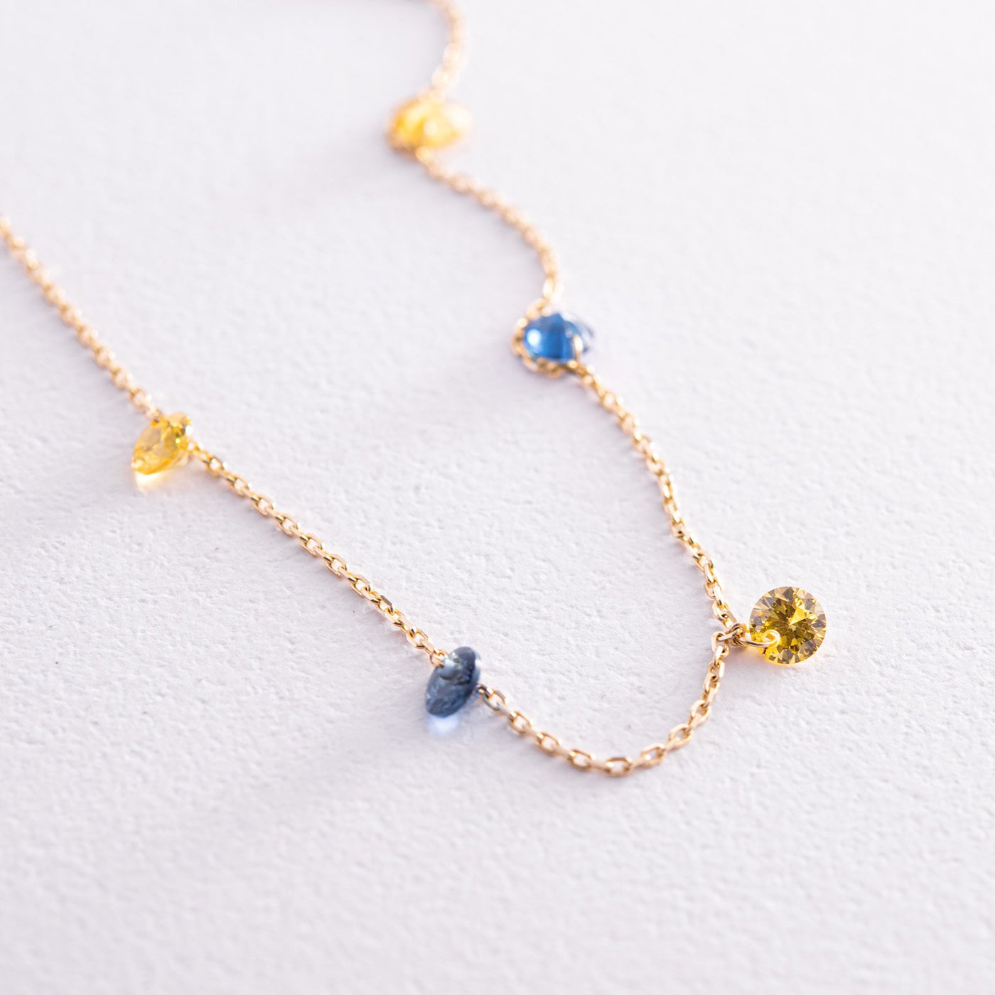 Gold anklet "Ukraine" (blue and yellow cubic zirconia)