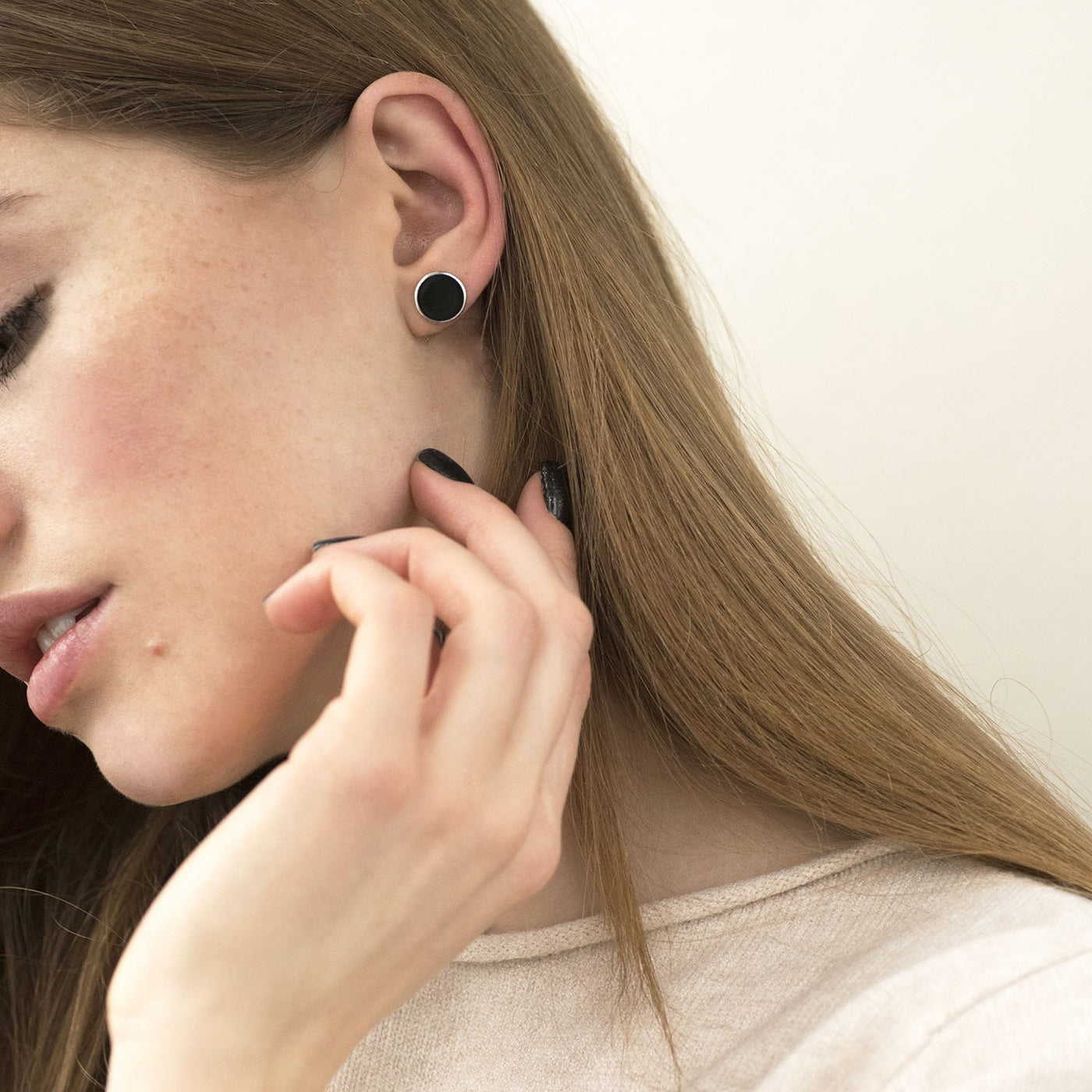 Silver stud earrings with black enamel