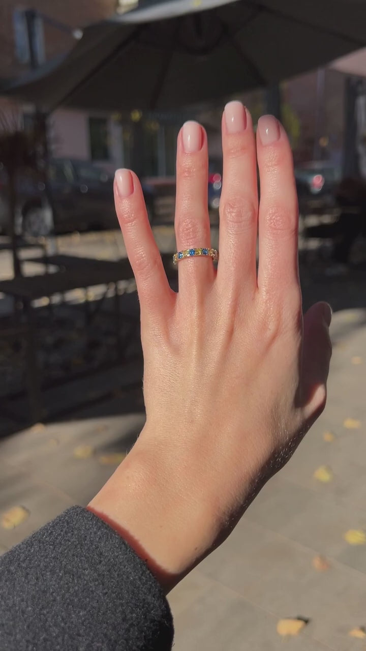 Ring with a path of blue and yellow cubic zirconia