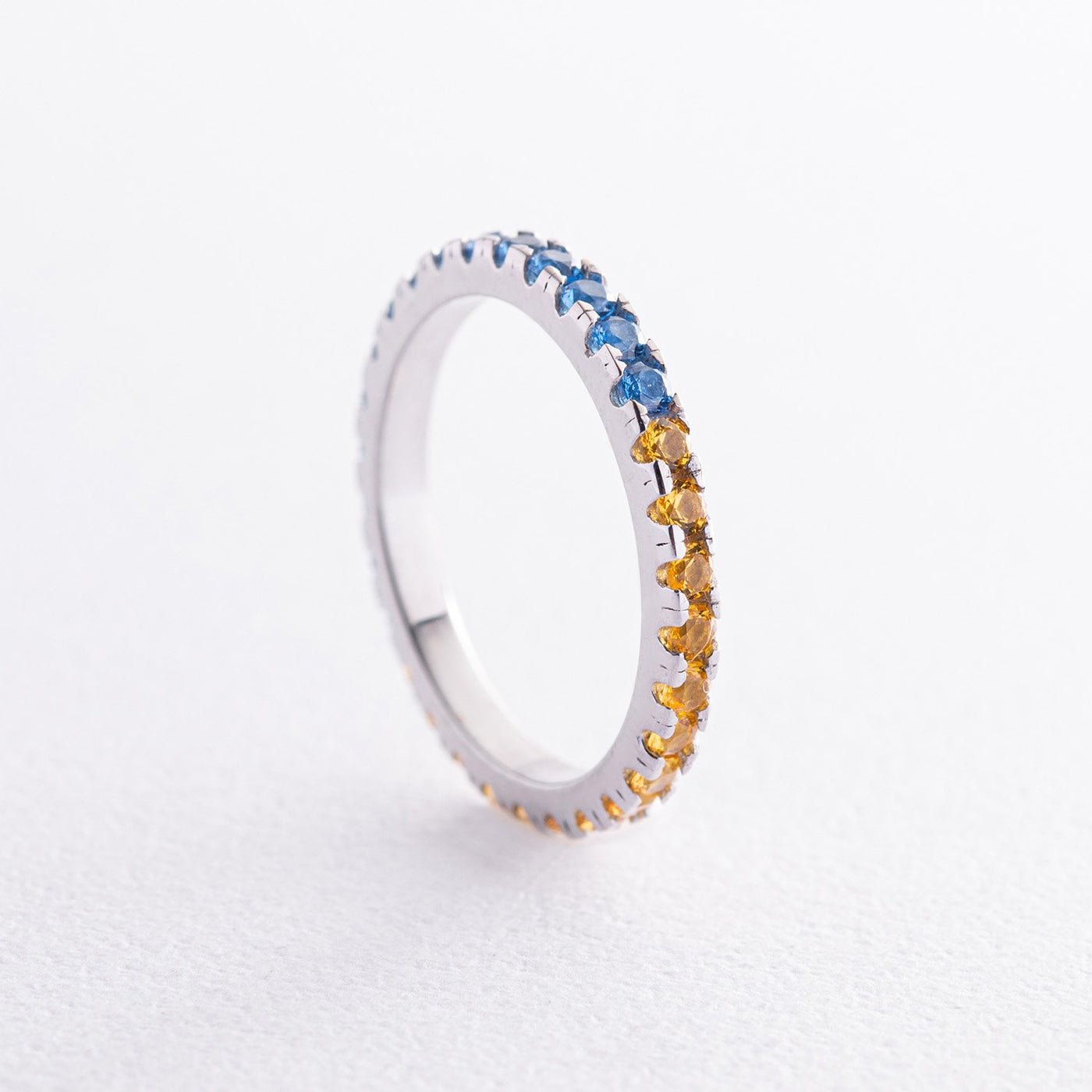 Ring with a path of blue and yellow cubic zirconia