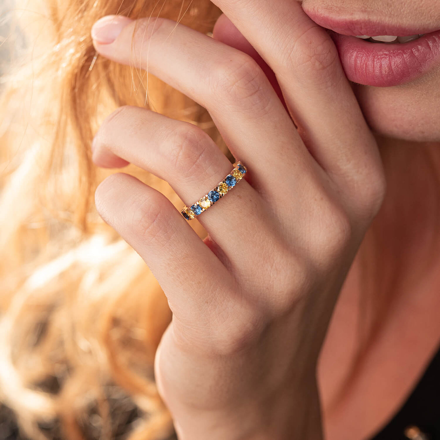 Ring with a path of blue and yellow cubic zirconia