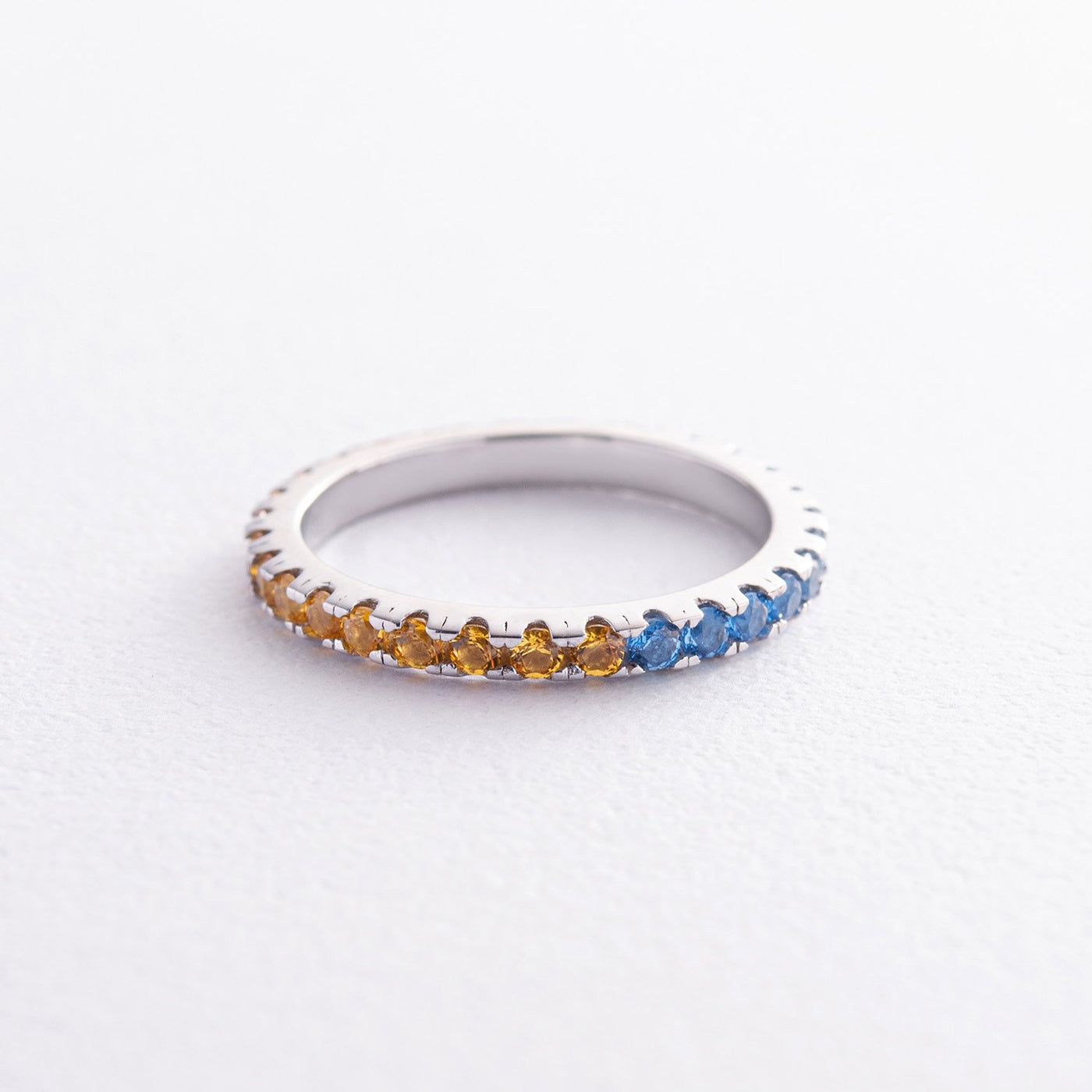 Ring with a path of blue and yellow cubic zirconia