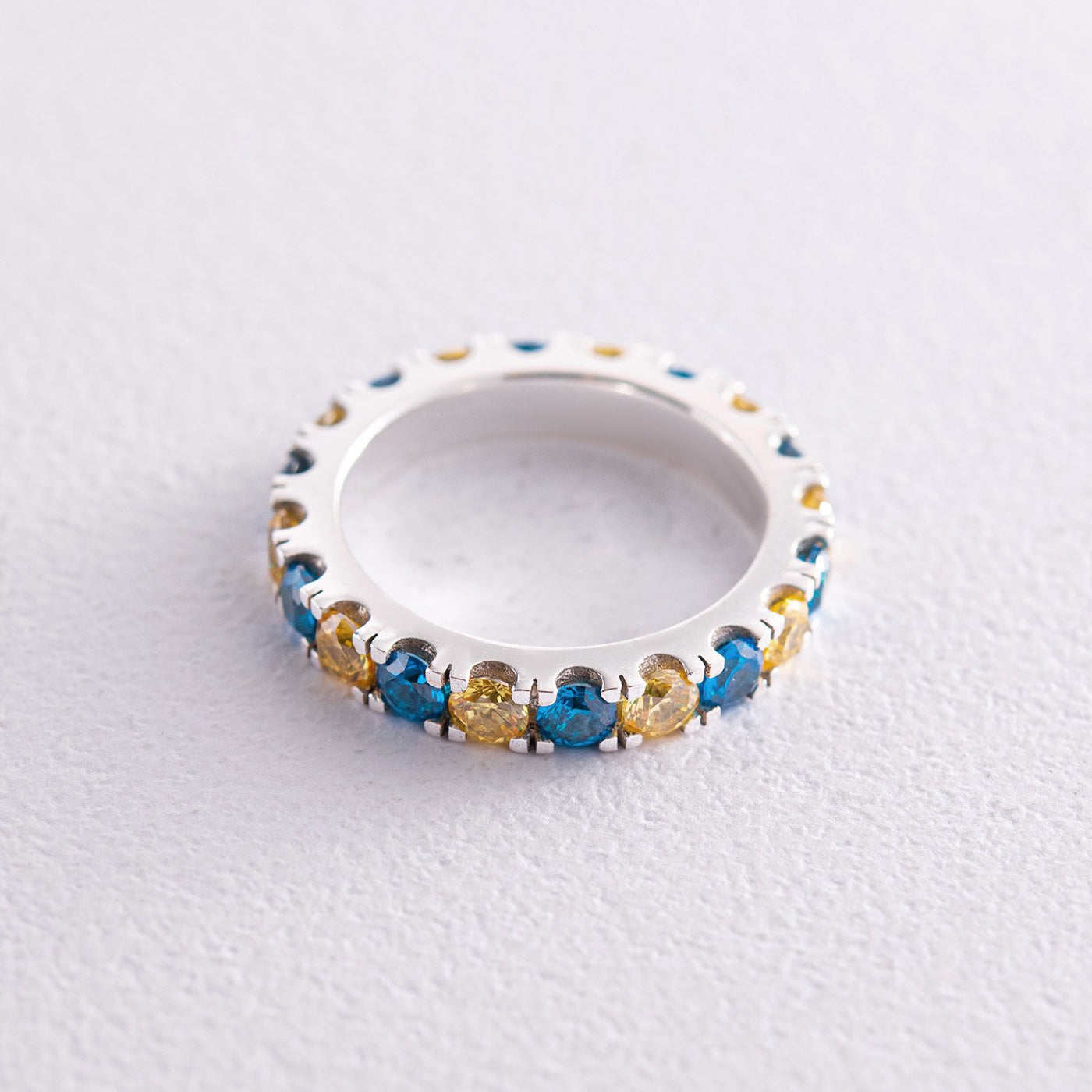 Ring with a path of blue and yellow cubic zirconia