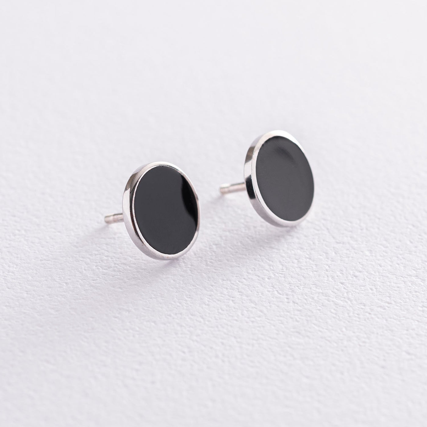 Silver stud earrings with black enamel