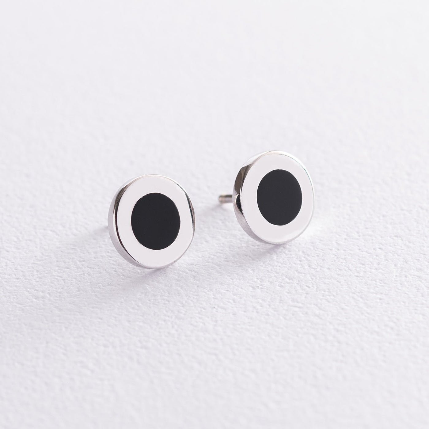 Silver stud earrings with black enamel