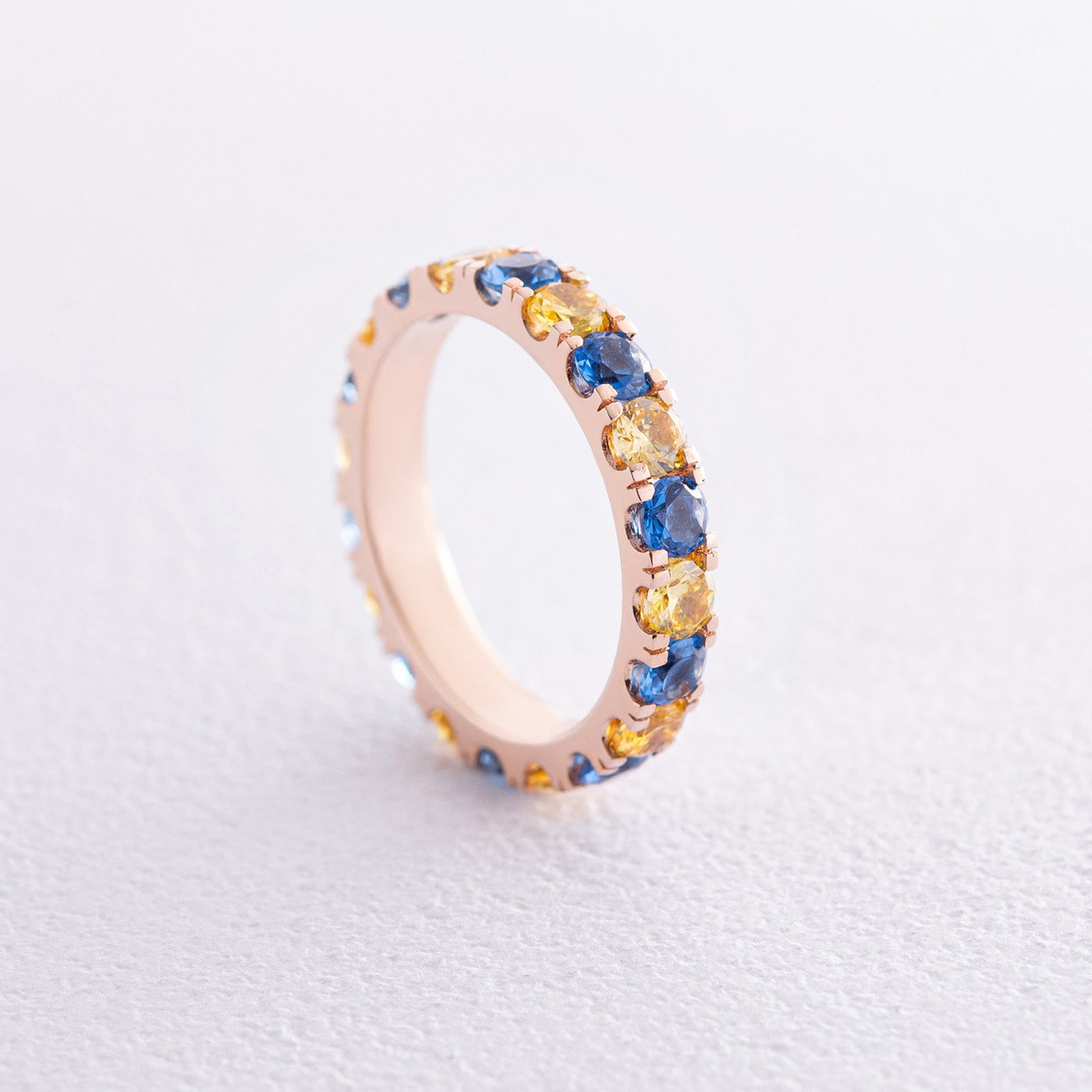 Ring with a path of blue and yellow cubic zirconia