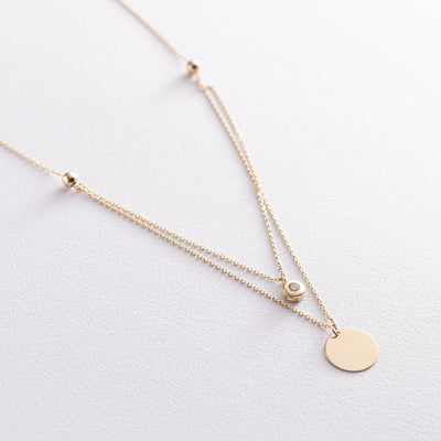 Gold necklace with a coin and cubic zirconia