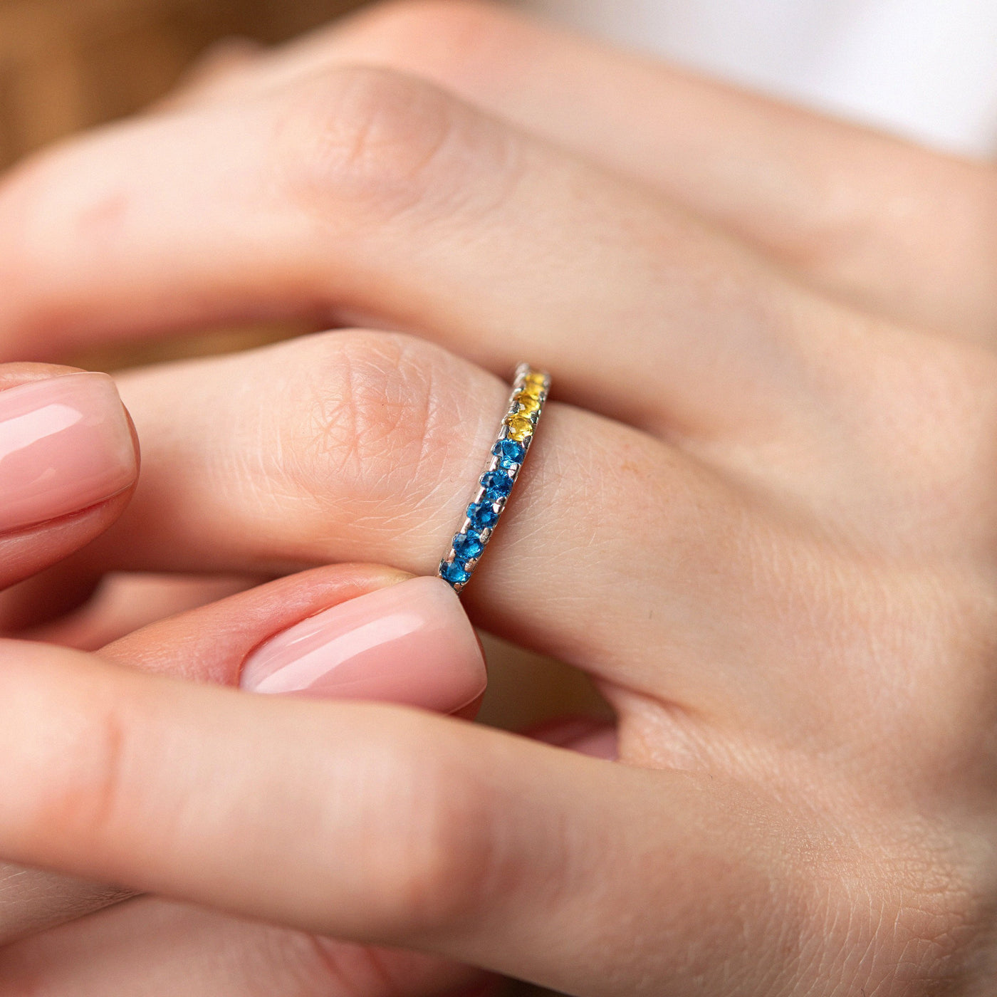 Ring with a path of blue and yellow cubic zirconia