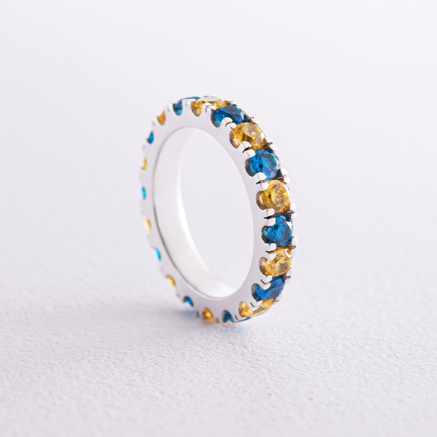 Ring with a path of blue and yellow cubic zirconia