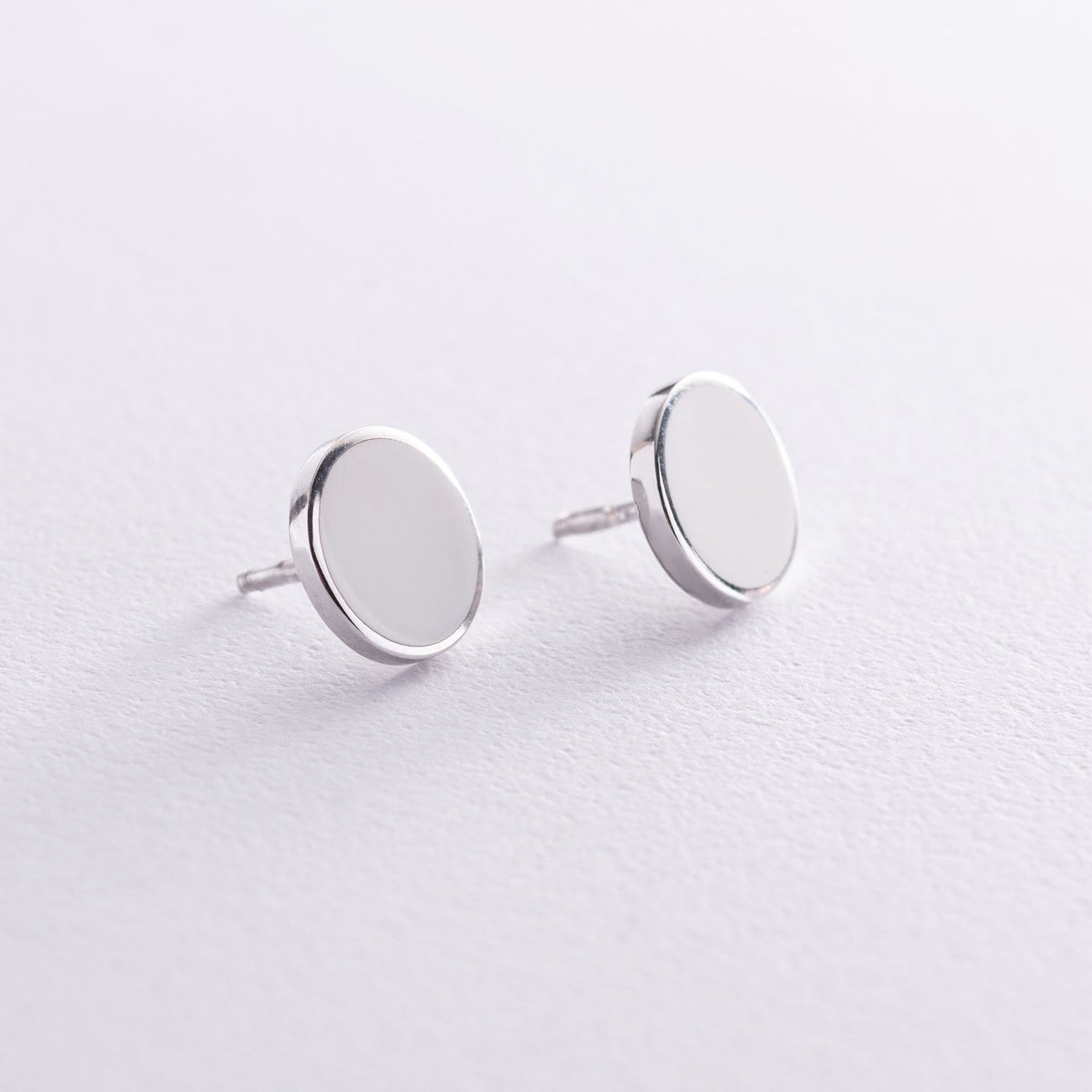 Silver stud earrings with white enamel