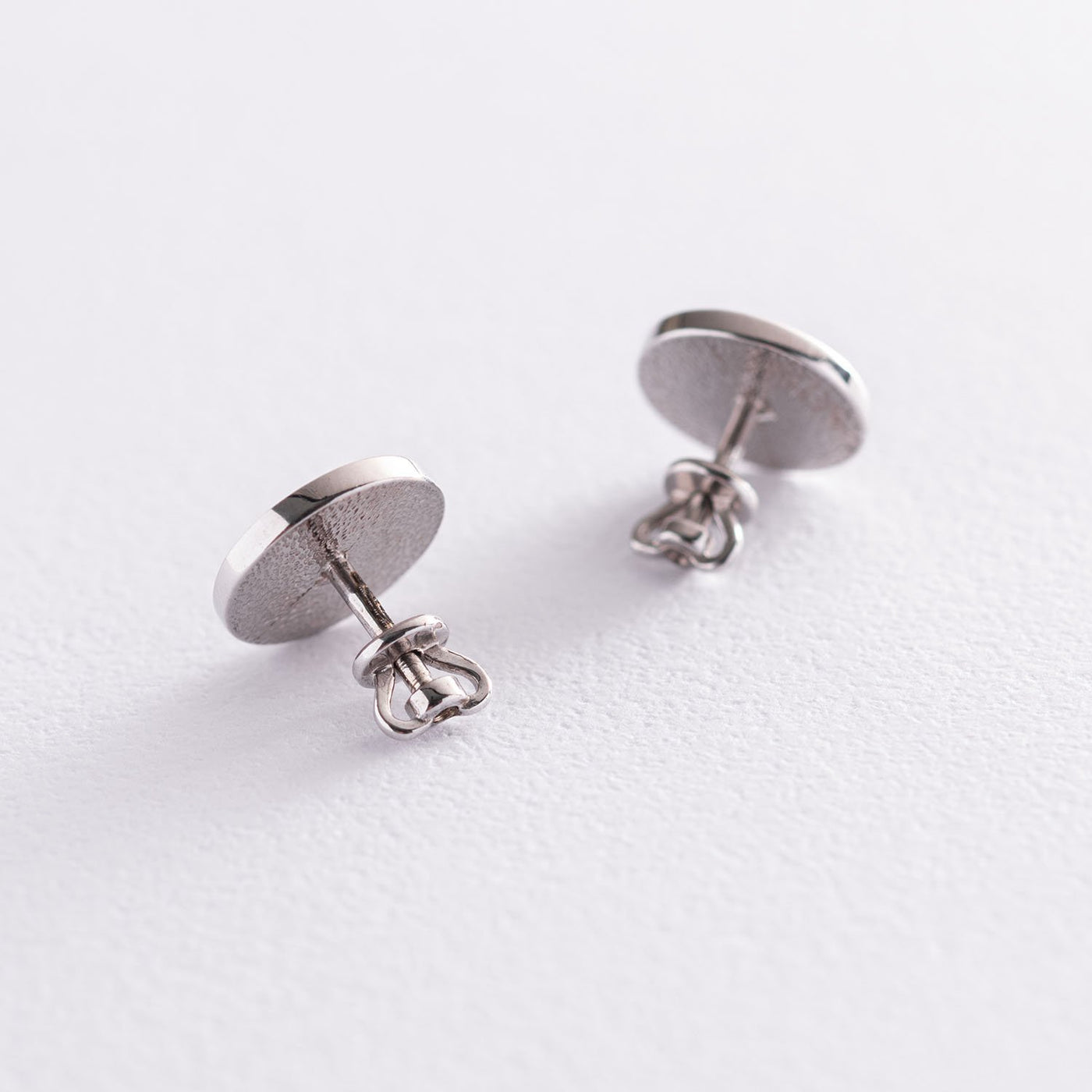 Silver stud earrings with black enamel