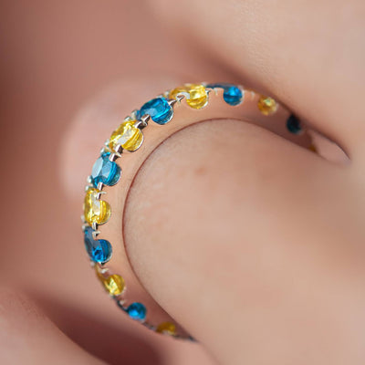 Ring with a path of blue and yellow cubic zirconia