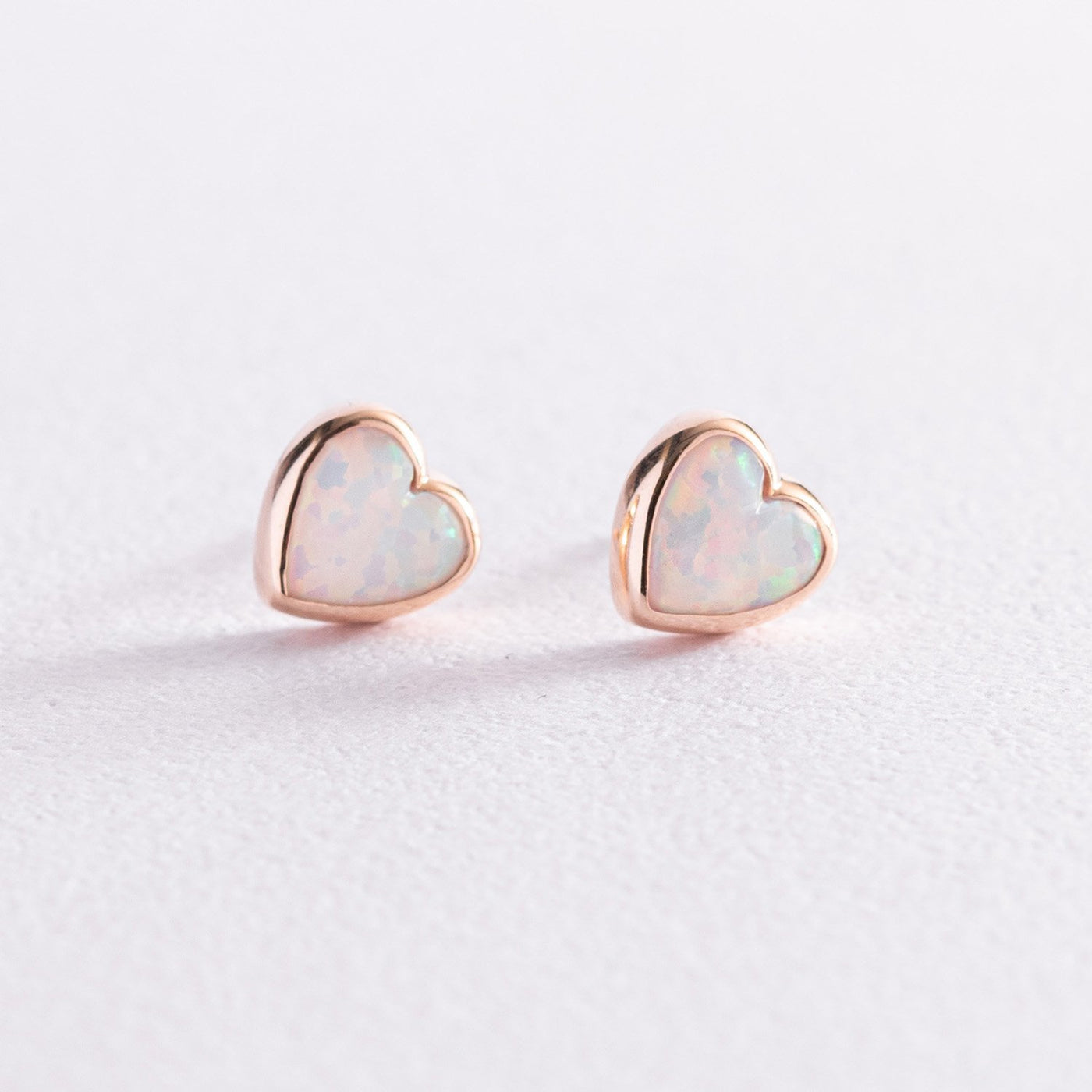 Gold heart stud earrings with opal