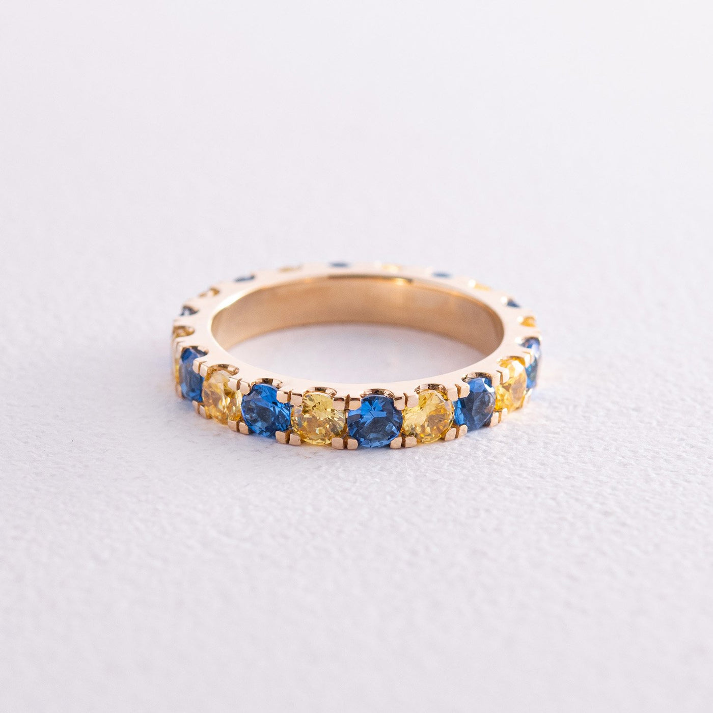 Ring with a path of blue and yellow cubic zirconia