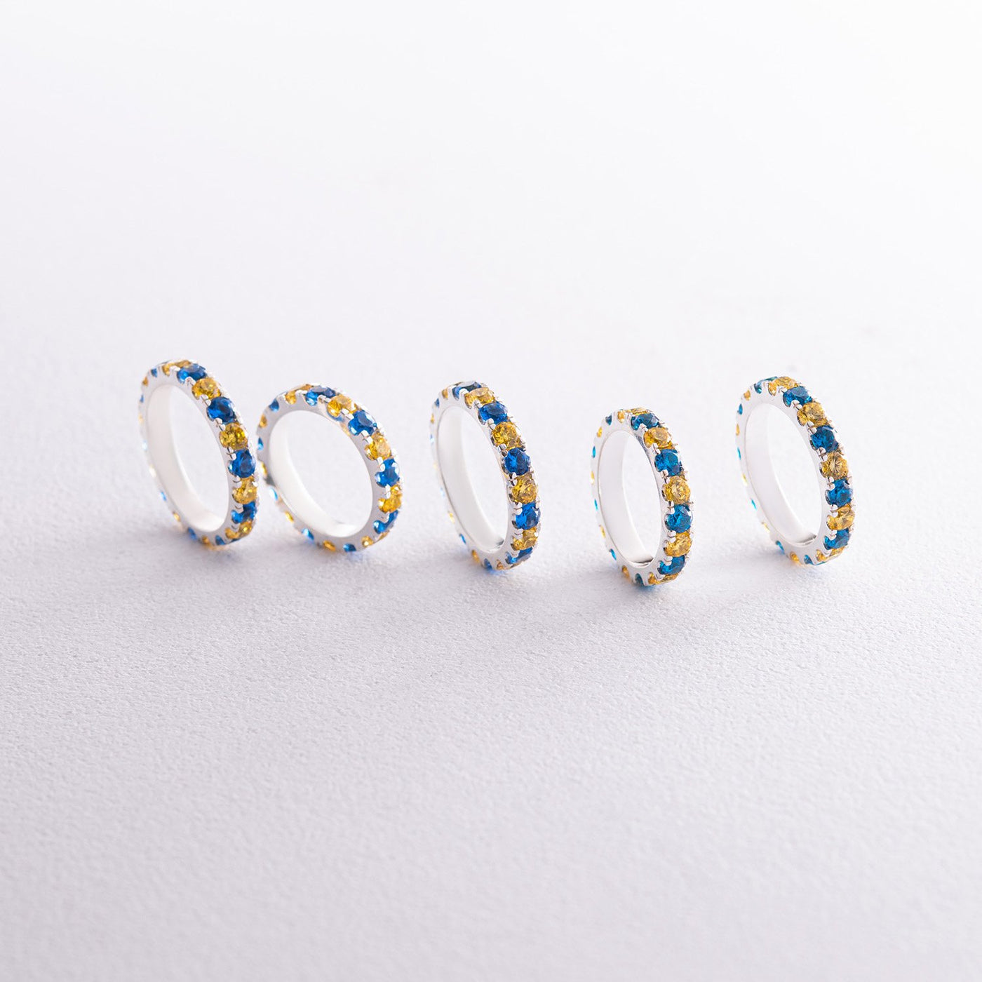 Ring with a path of blue and yellow cubic zirconia