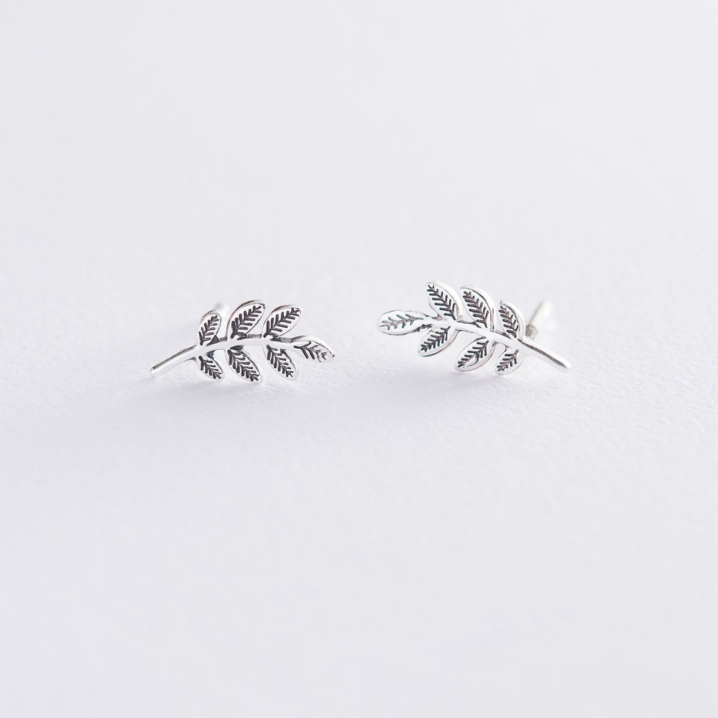 Silver stud leaves earrings