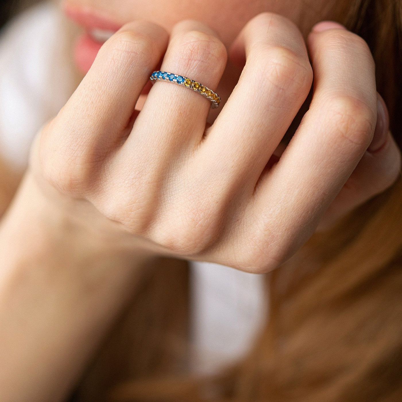 Ring with a path of blue and yellow cubic zirconia