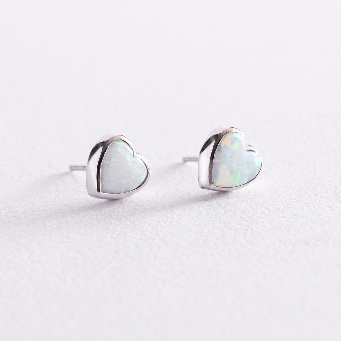 Gold heart stud earrings with opal