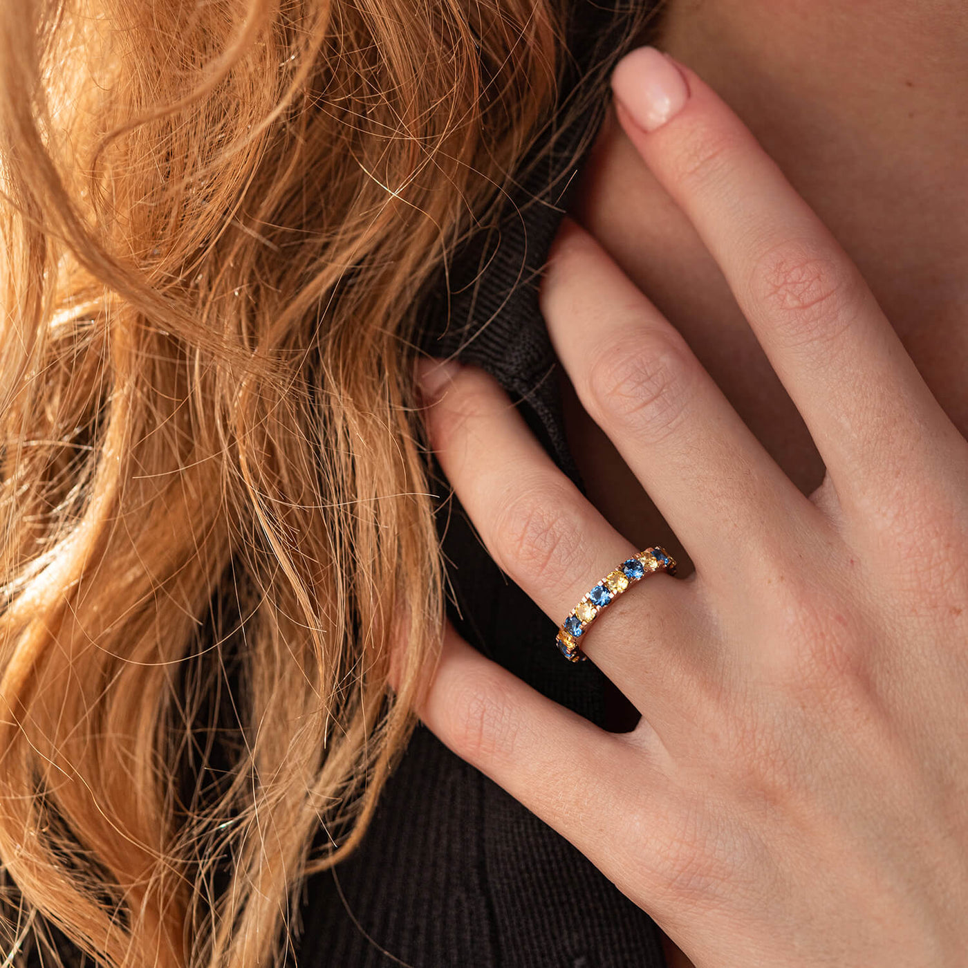 Ring with a path of blue and yellow cubic zirconia