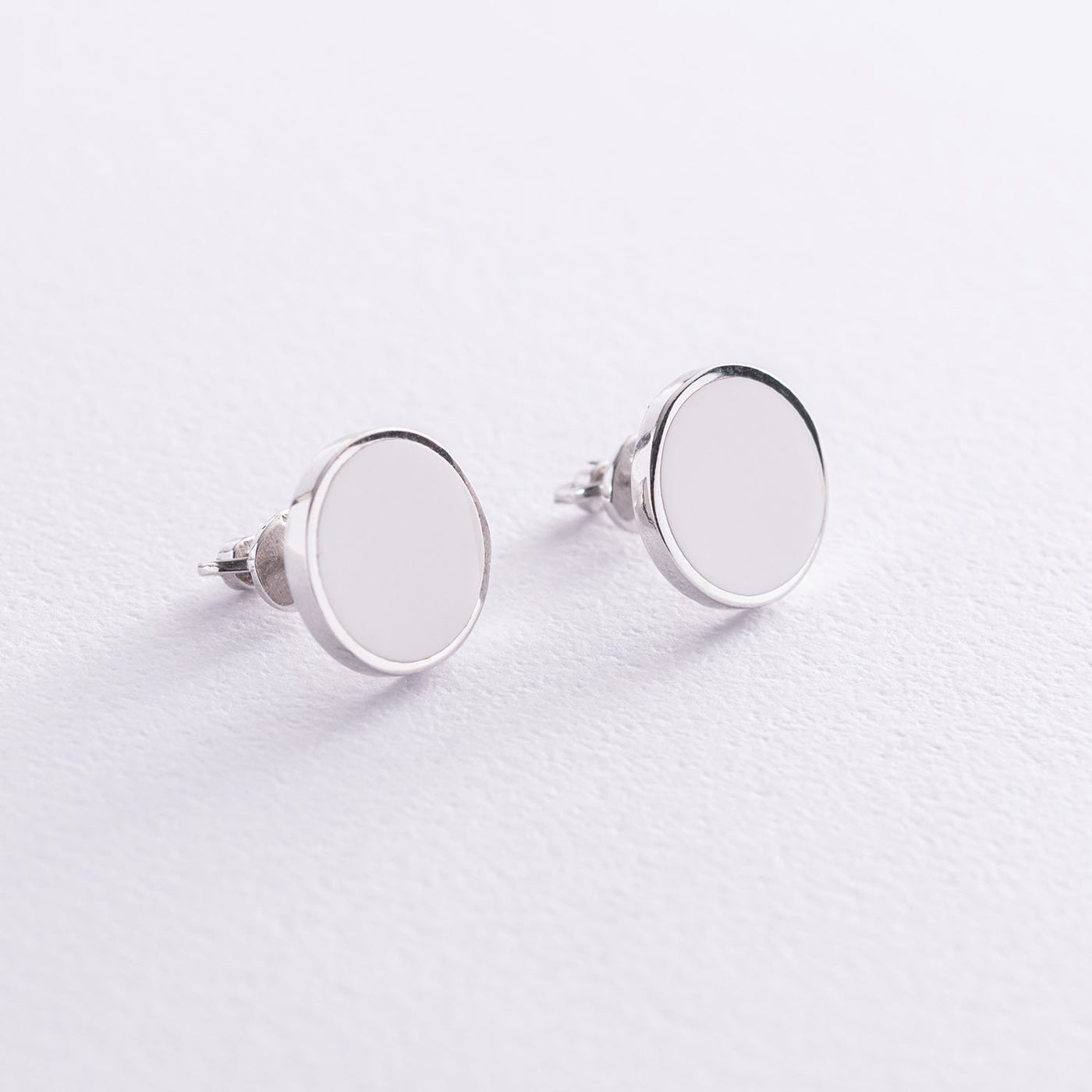 Silver stud earrings with white enamel