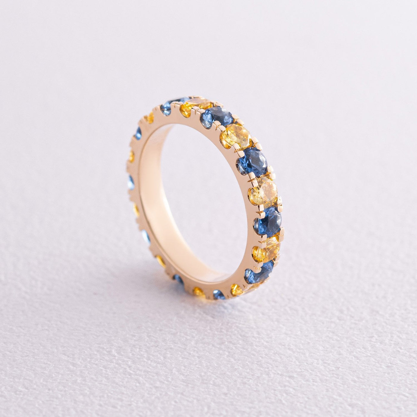 Ring with a path of blue and yellow cubic zirconia