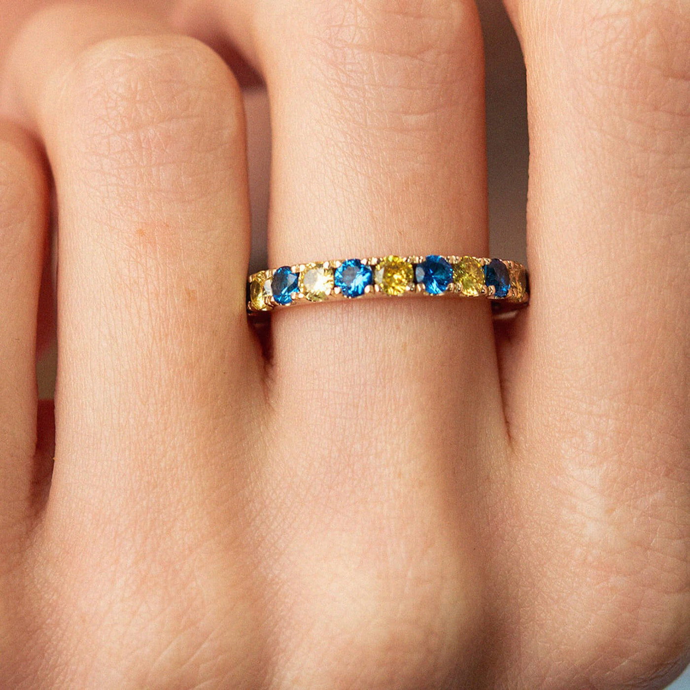 Ring with a path of blue and yellow cubic zirconia