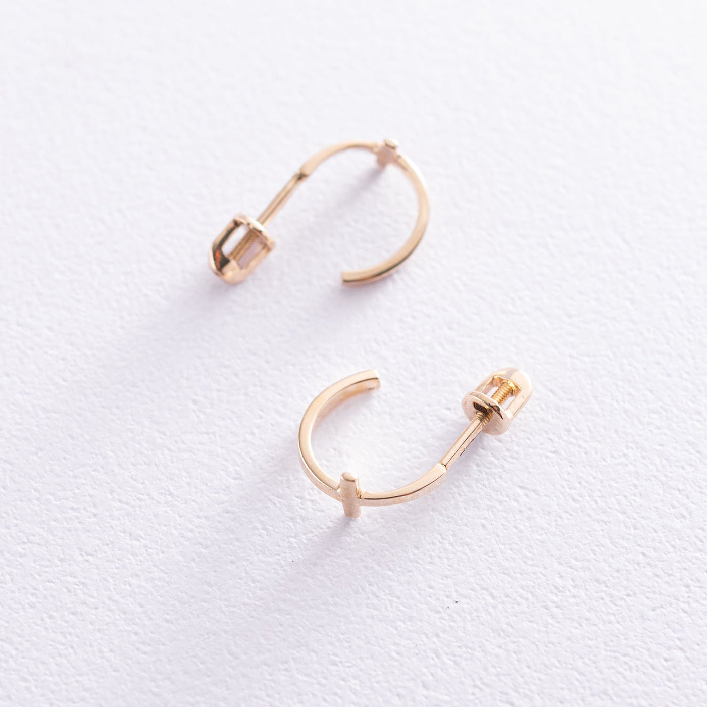 Gold cross stud earrings