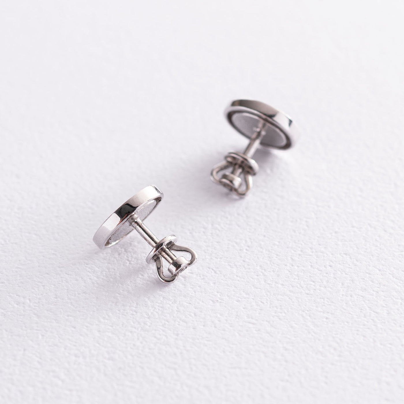 Silver stud earrings with black enamel