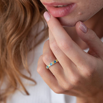 Ring with a path of blue and yellow cubic zirconia