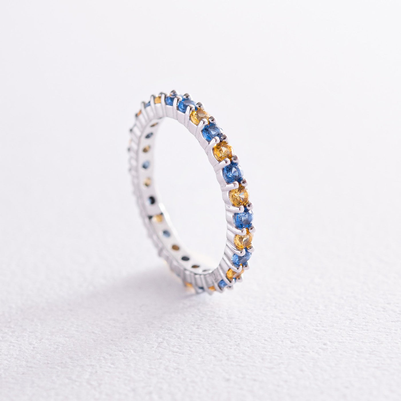 Ring with a path of blue and yellow cubic zirconia