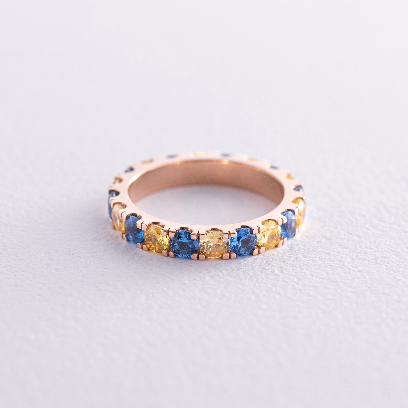 Ring with a path of blue and yellow cubic zirconia