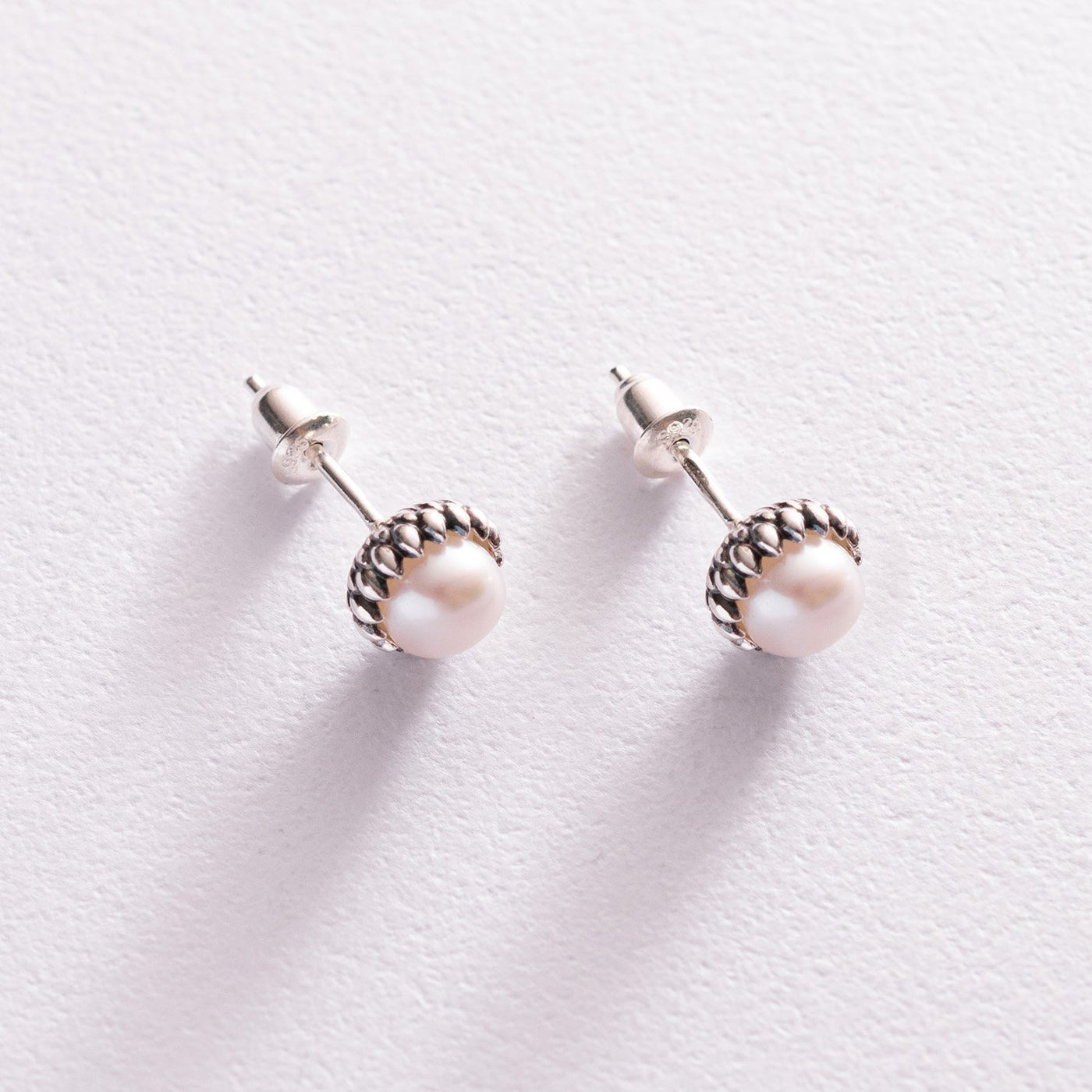 Silver stud earrings with pearls