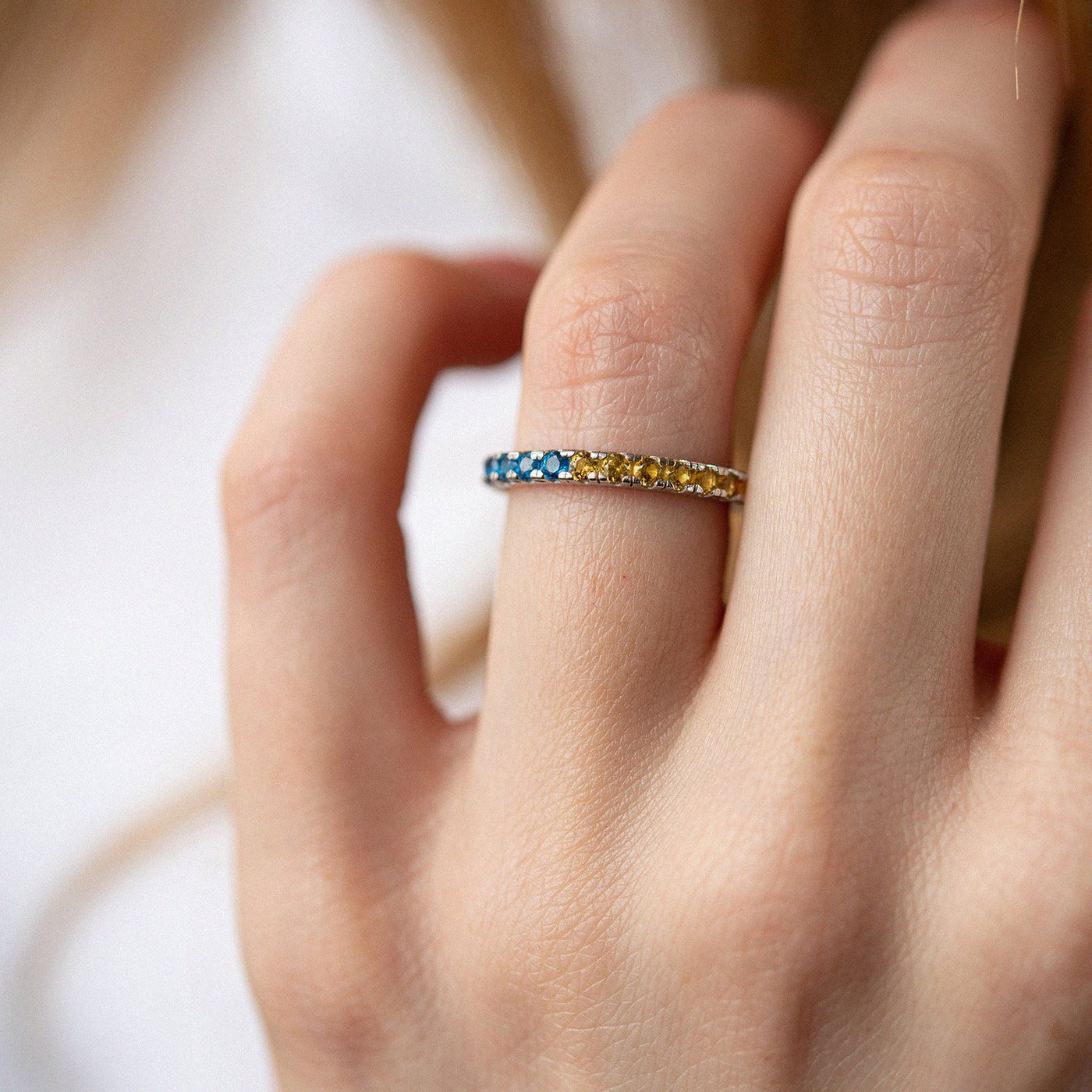 Ring with a path of blue and yellow cubic zirconia