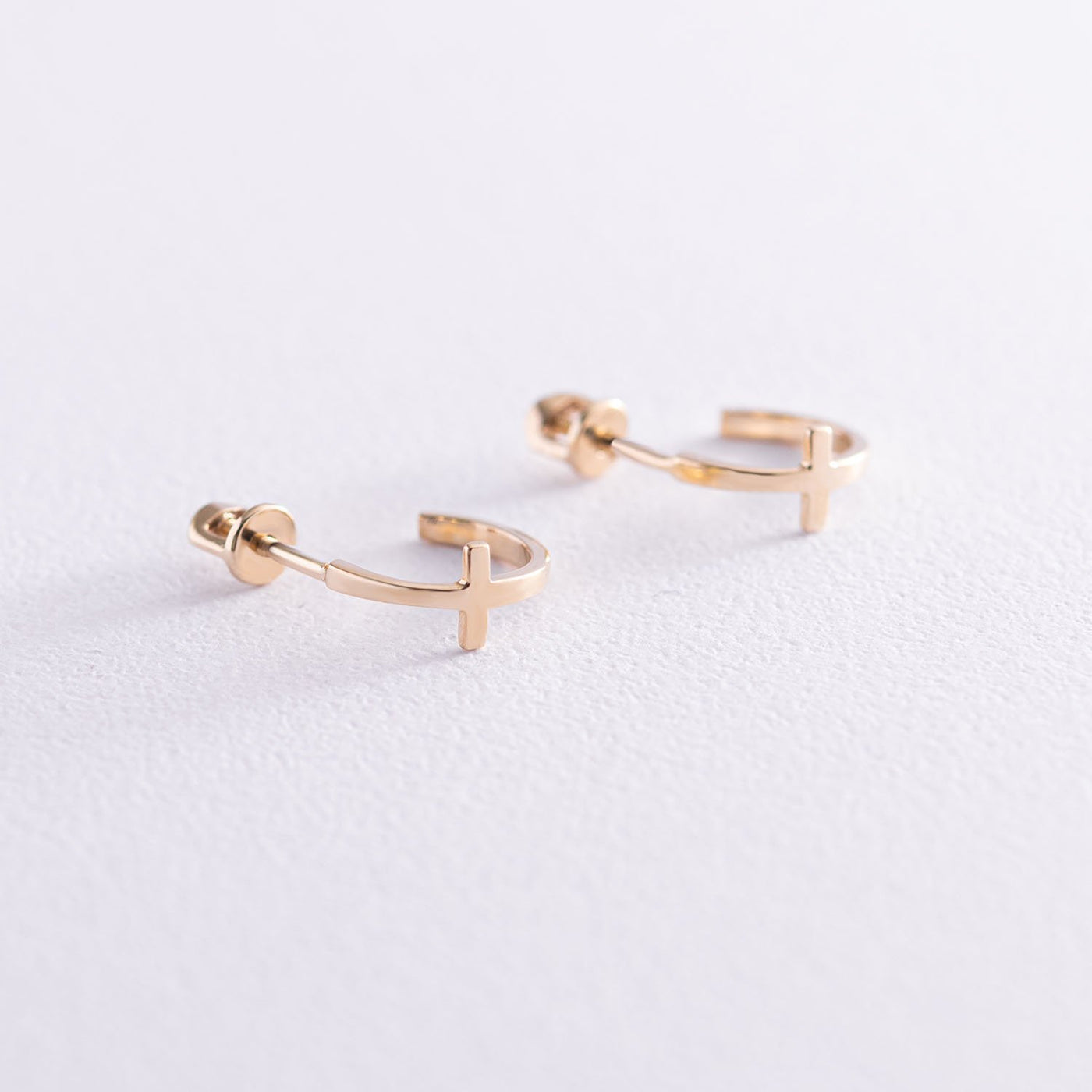 Gold cross stud earrings