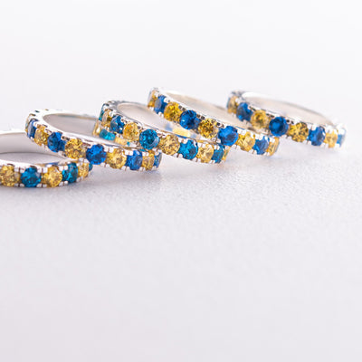 Ring with a path of blue and yellow cubic zirconia