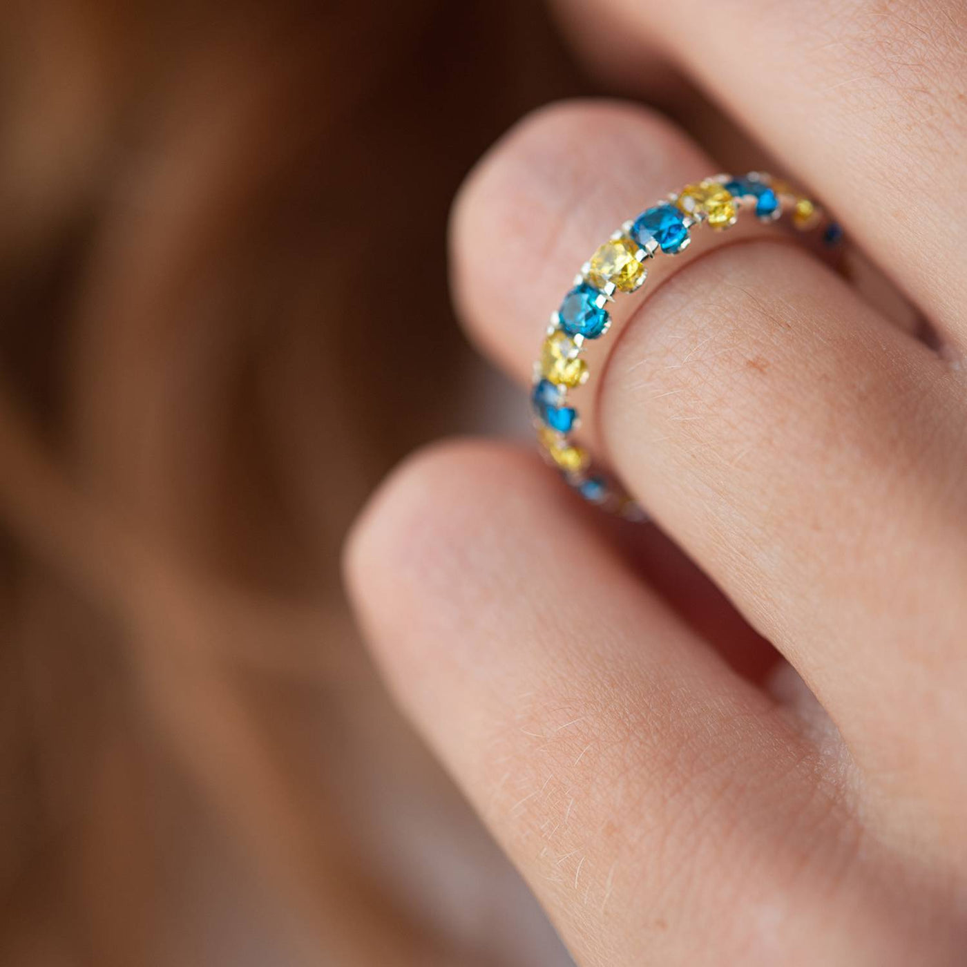 Ring with a path of blue and yellow cubic zirconia