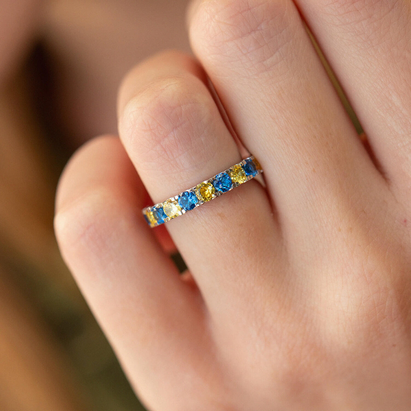 Ring with a path of blue and yellow cubic zirconia