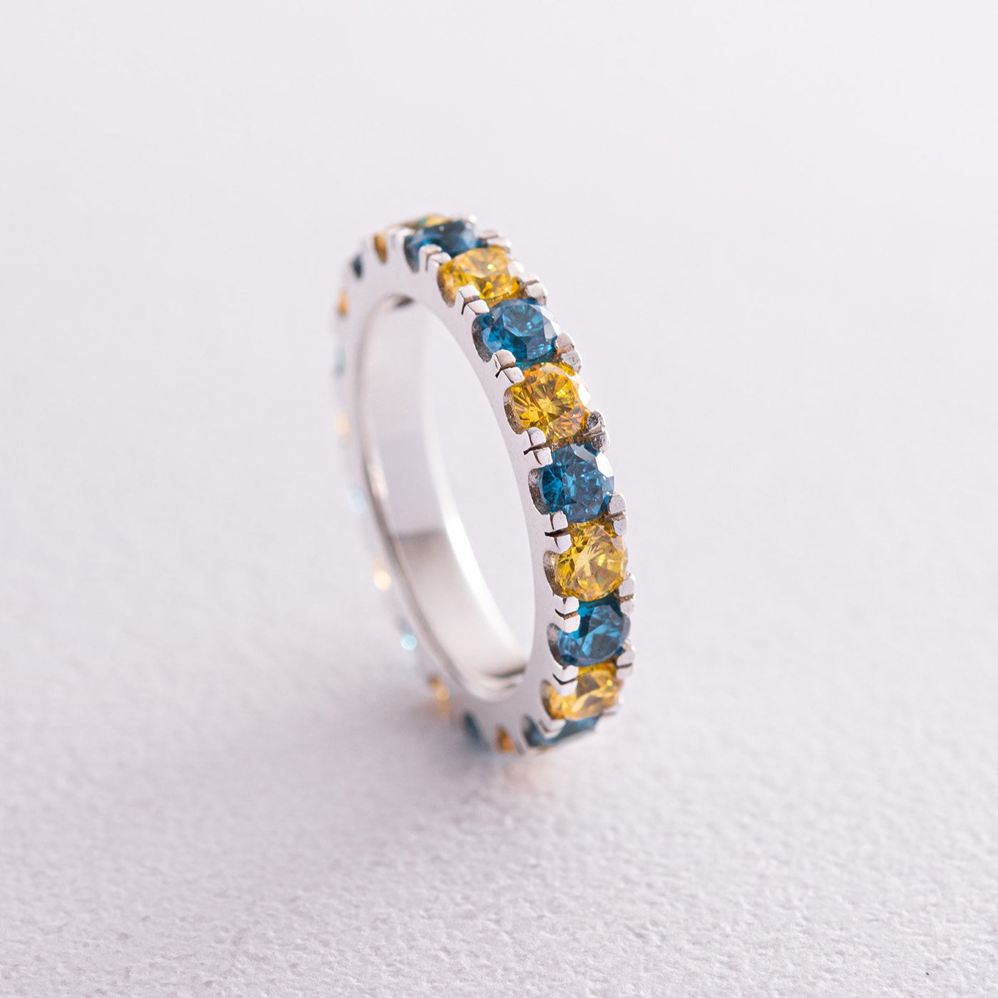 Ring with a path of blue and yellow cubic zirconia