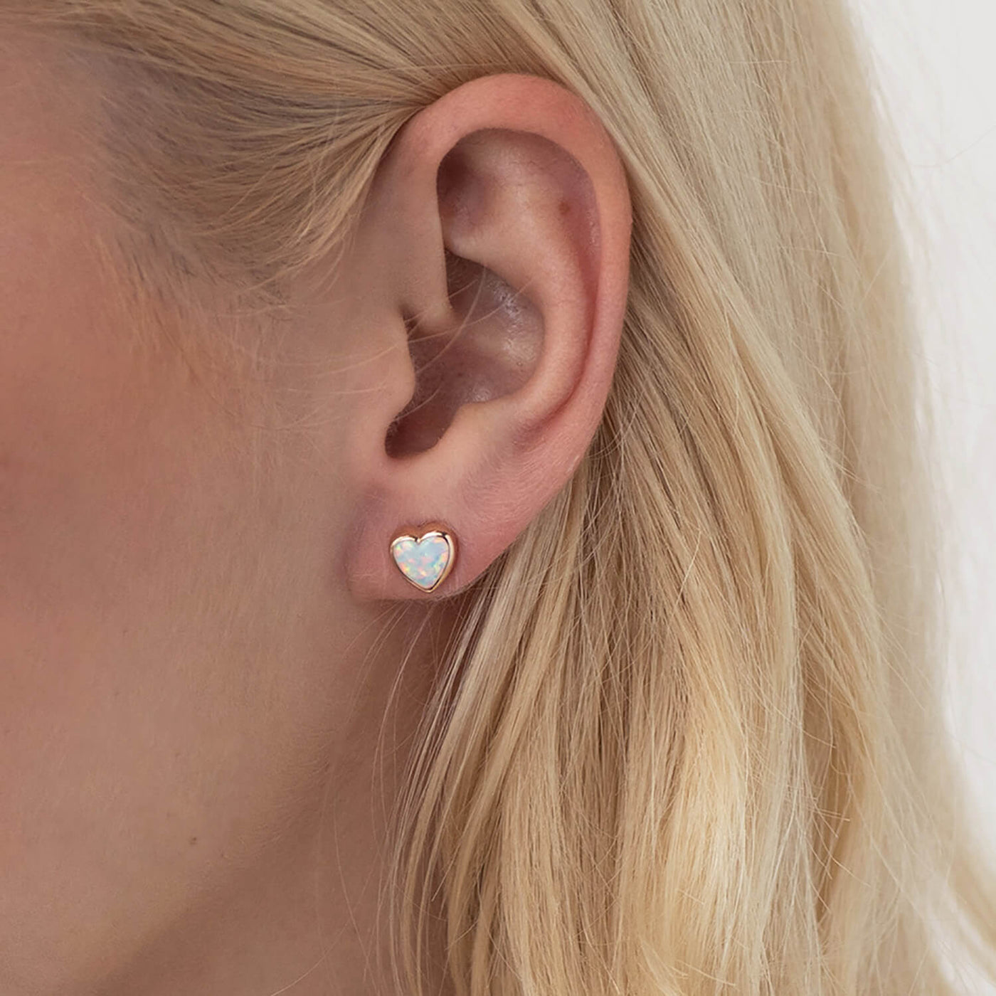 Gold heart stud earrings with opal