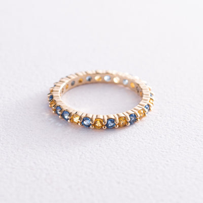 Ring with a path of blue and yellow cubic zirconia