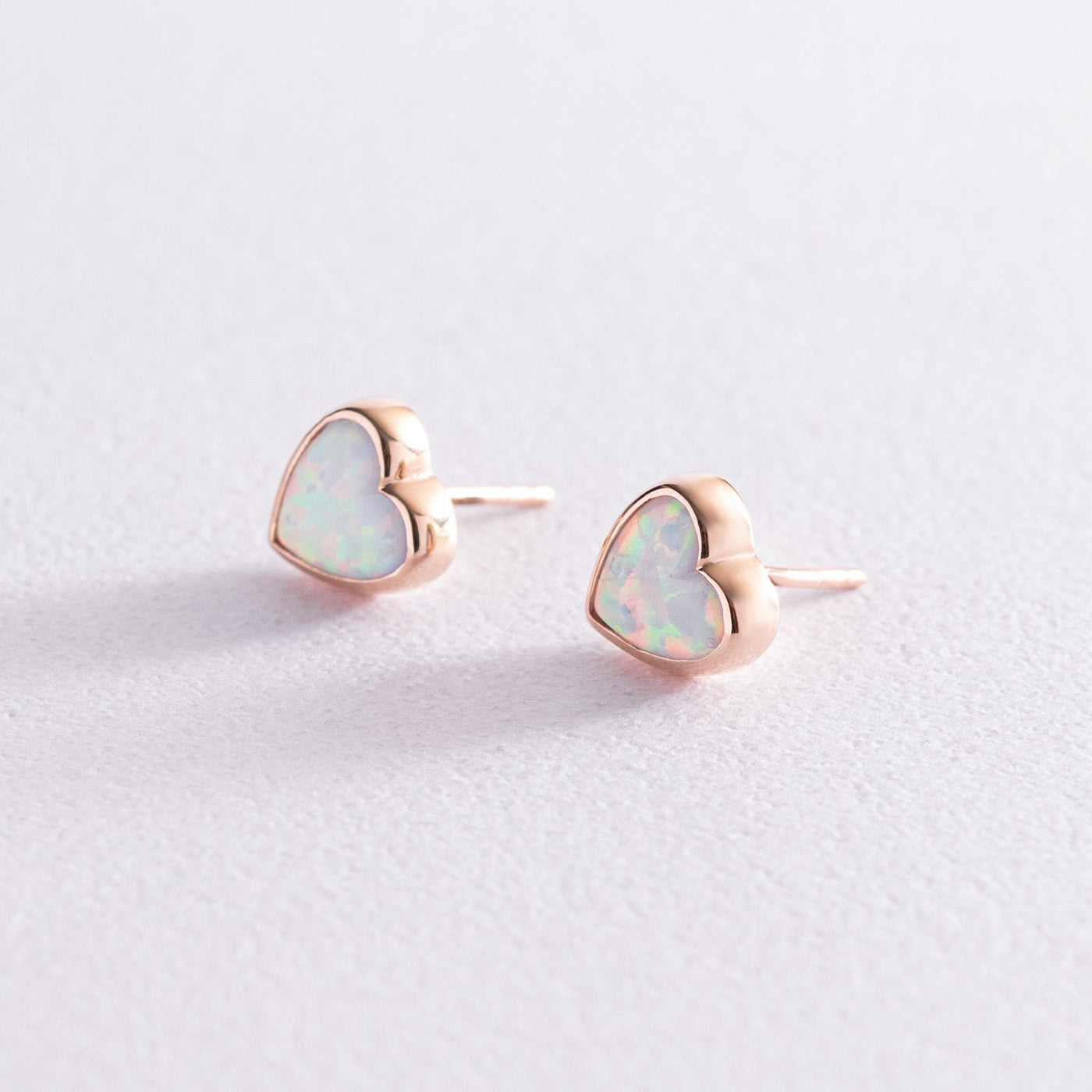 Gold heart stud earrings with opal