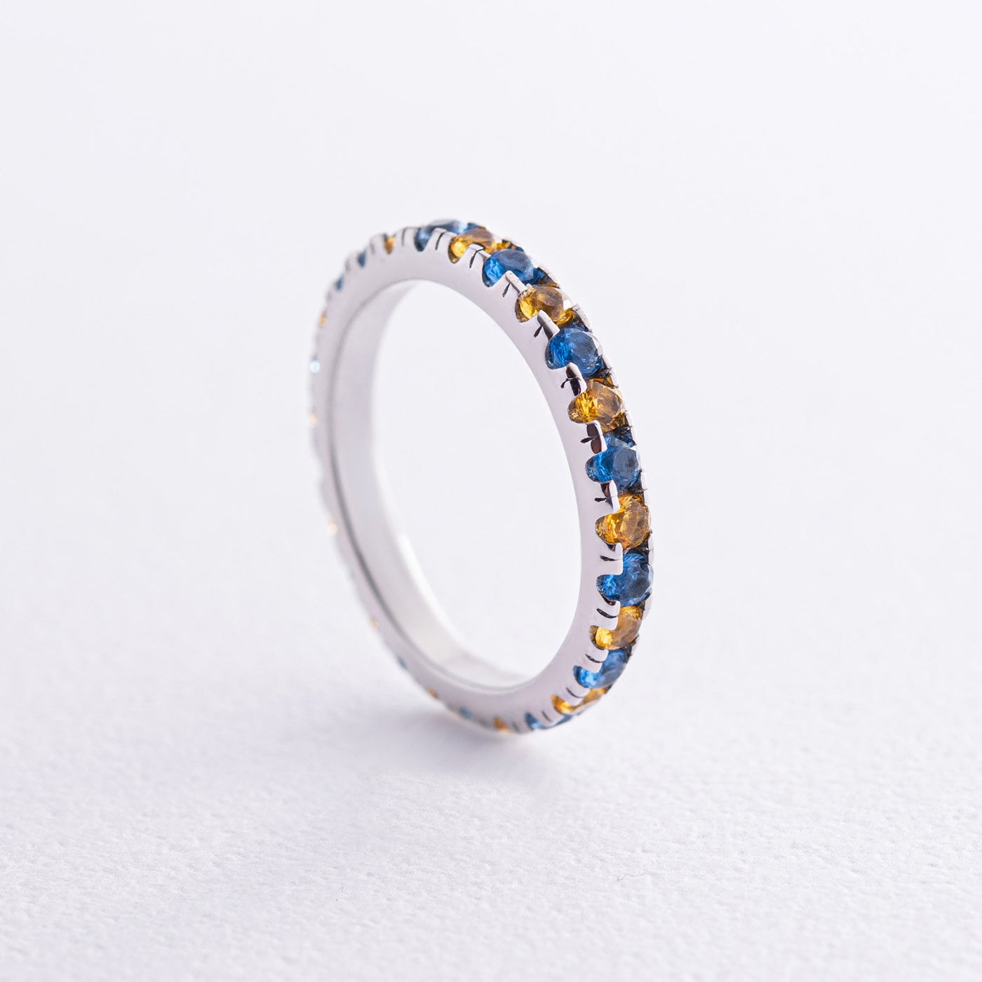 Ring with a path of blue and yellow cubic zirconia