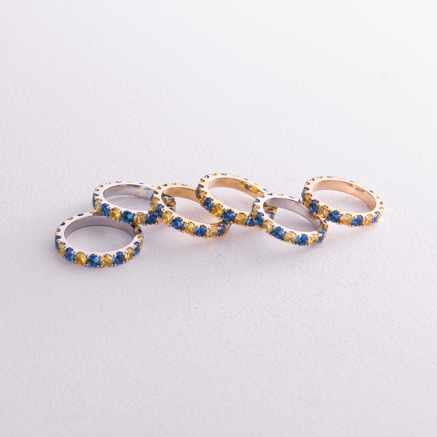 Ring with a path of blue and yellow cubic zirconia