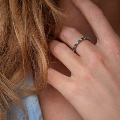 Ring with a path of blue and yellow cubic zirconia