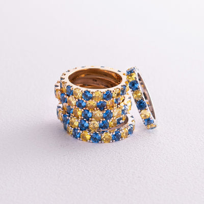 Ring with a path of blue and yellow cubic zirconia