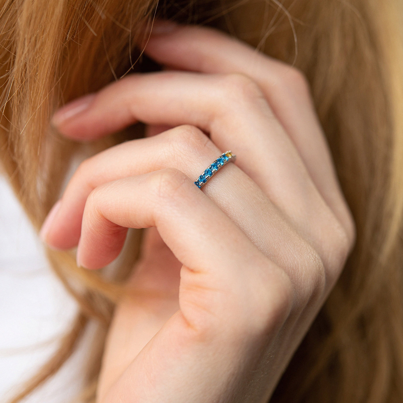 Ring with a path of blue and yellow cubic zirconia